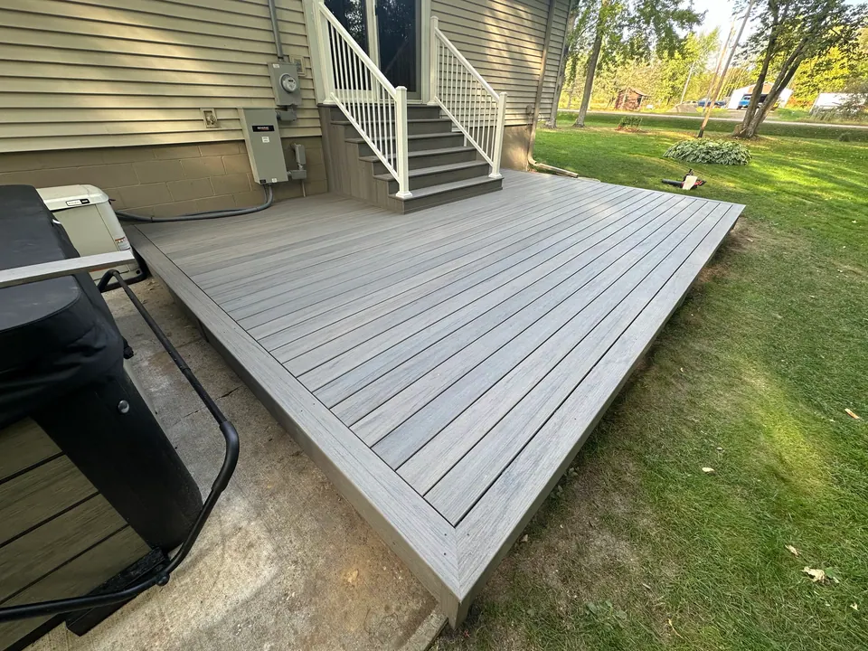 Composite platform deck beside a house
