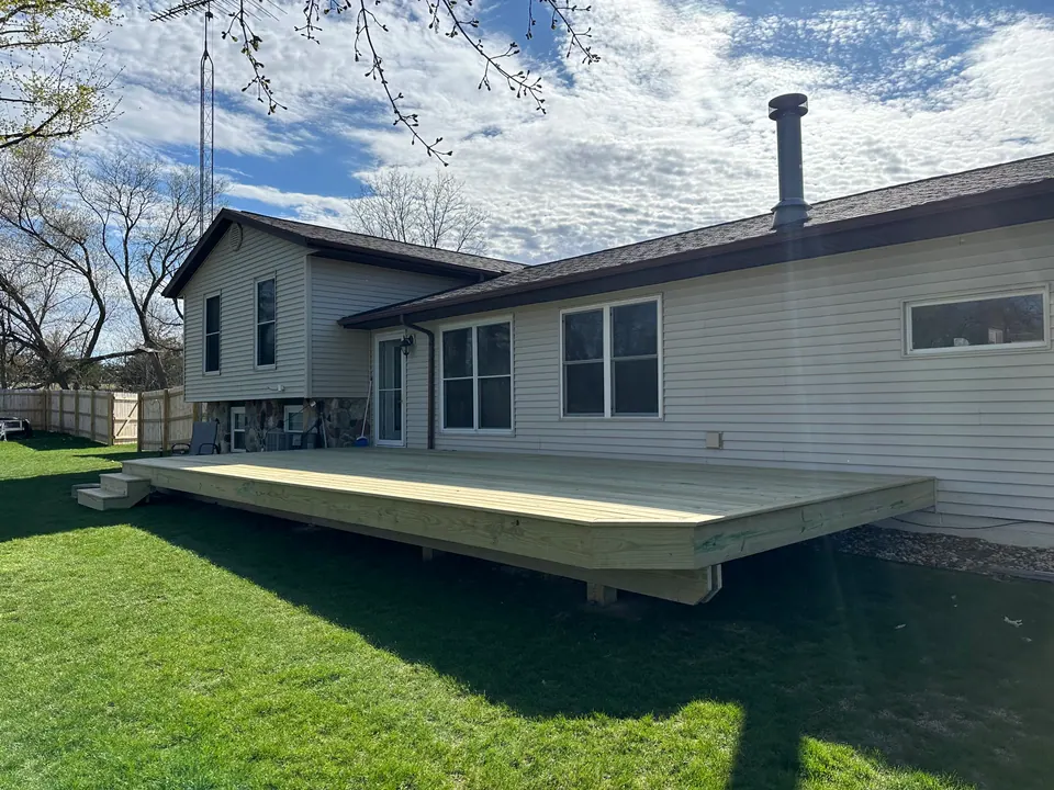 Freestanding platform deck in a grassy backyard